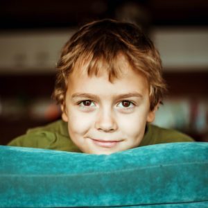 boy in green shirt smiling